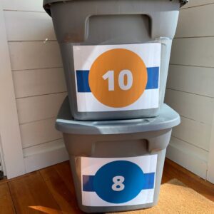 Bins storing kids clothing with size labels on the front - Livable Solutions blog.
